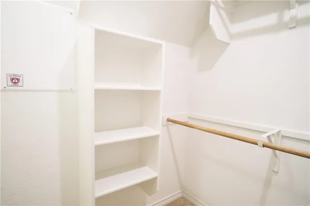 a view of a livingroom with a ceiling fan and window