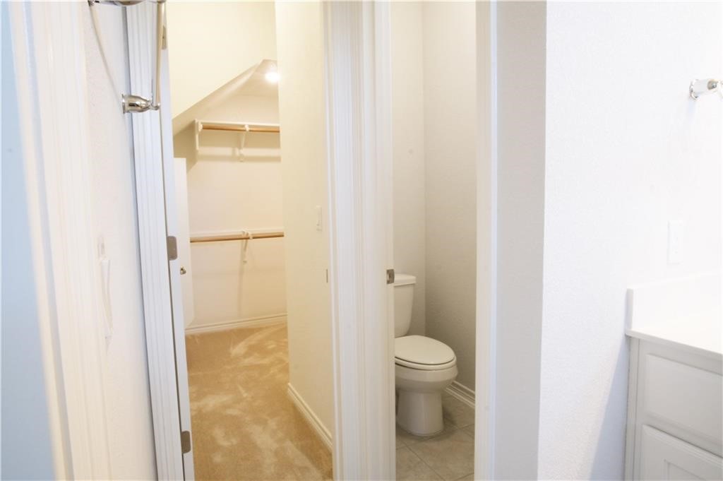 14110 McCoy Loop Austin, TX 78717 - Photo 16 of 35 a bathroom with a granite countertop shower and a toilet