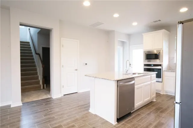 a view of a kitchen with a sink and a window