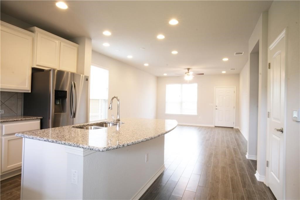 14110 McCoy Loop Austin, TX 78717 - Photo 4 of 35 a kitchen with kitchen island a sink appliances and cabinets