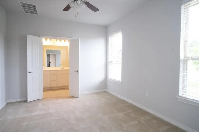 a bathroom with a sink shower and a mirror