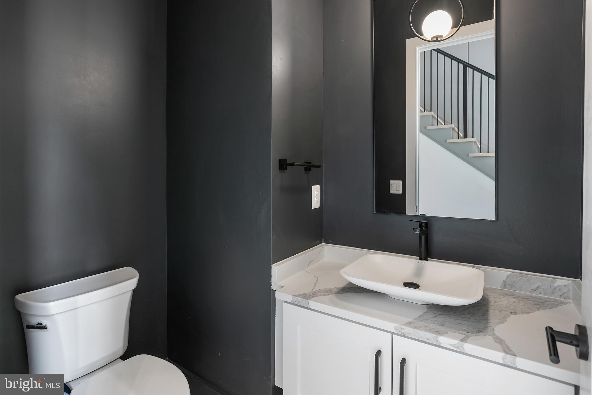 7019 Statendam Court McLean, VA 22101 - Photo 18 of 52 a bathroom with a granite countertop sink and a toilet