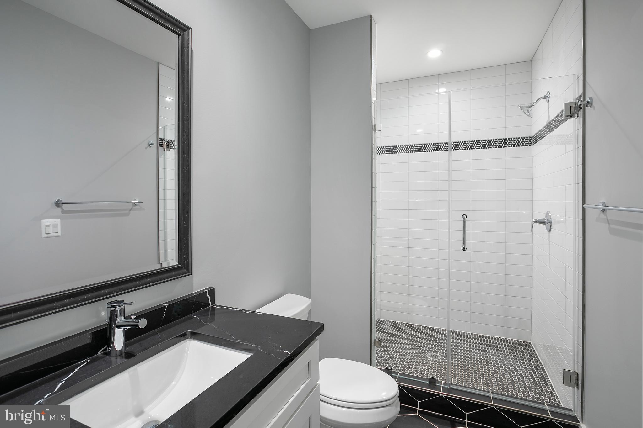 7019 Statendam Court McLean, VA 22101 - Photo 23 of 52 a bathroom with a sink a toilet and shower