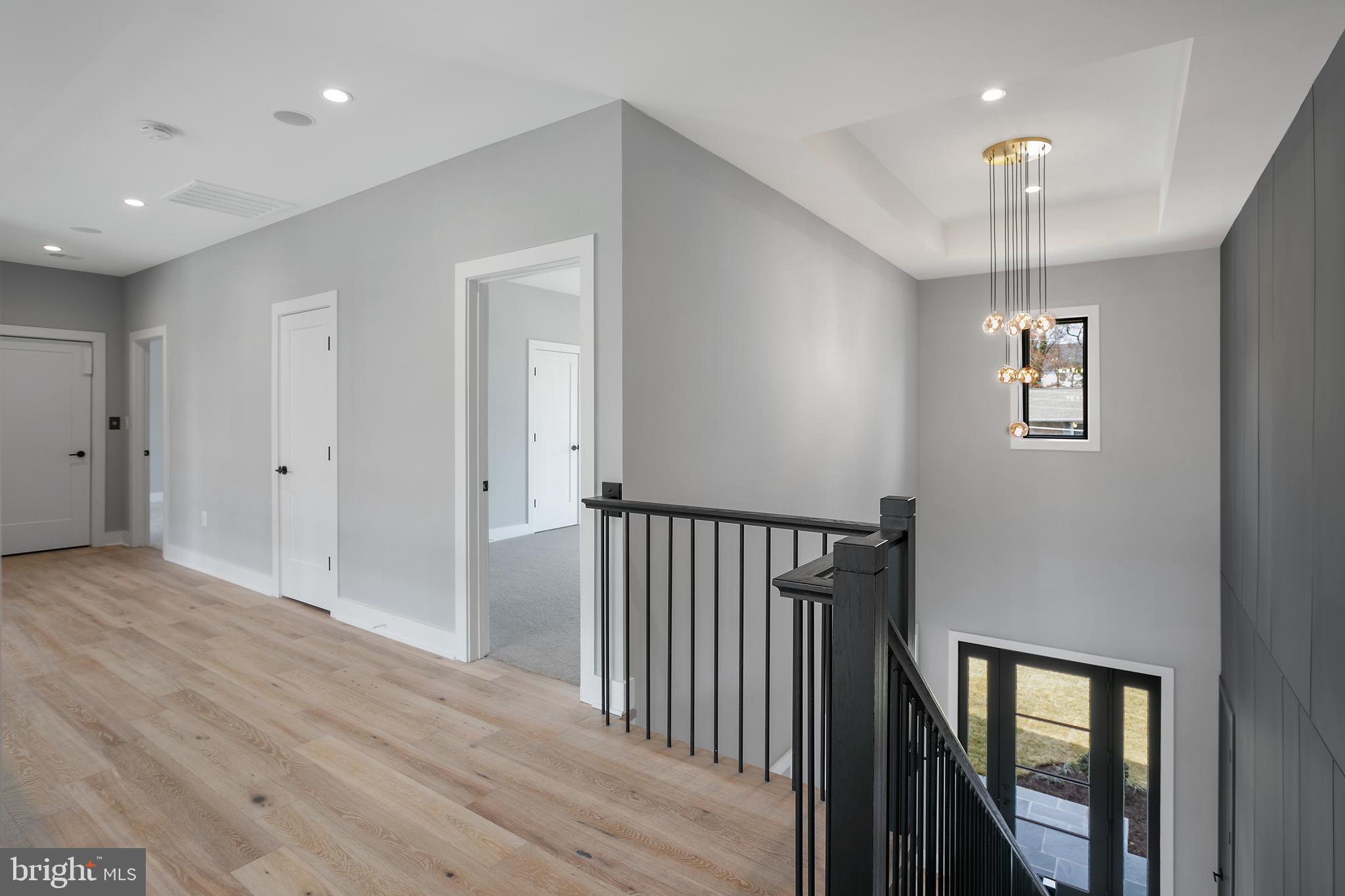 7019 Statendam Court McLean, VA 22101 - Photo 32 of 52 a view of a hallway with wooden floor and chandelier