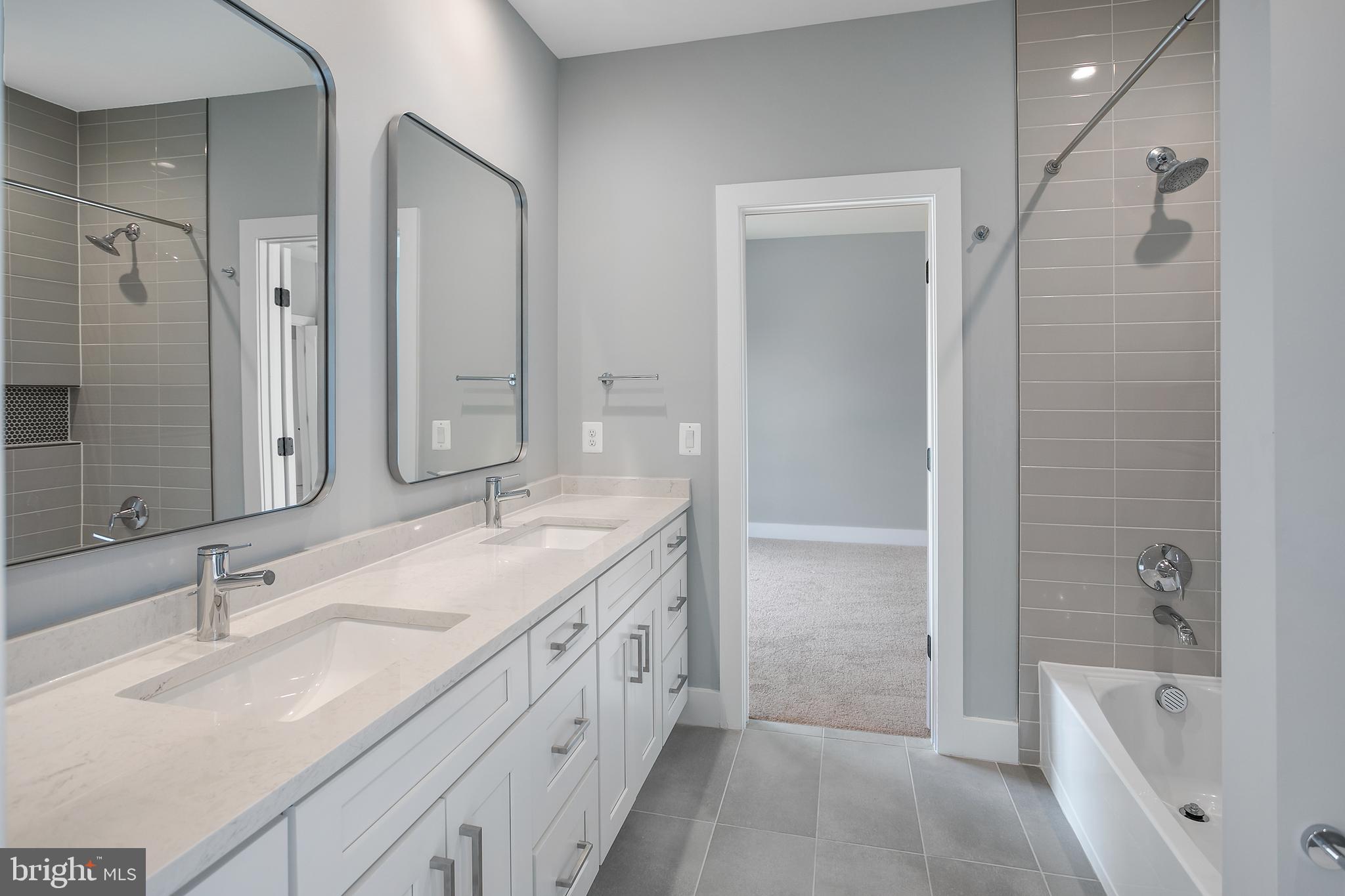 7019 Statendam Court McLean, VA 22101 - Photo 43 of 52 a bathroom with a granite countertop sink shower and a mirror