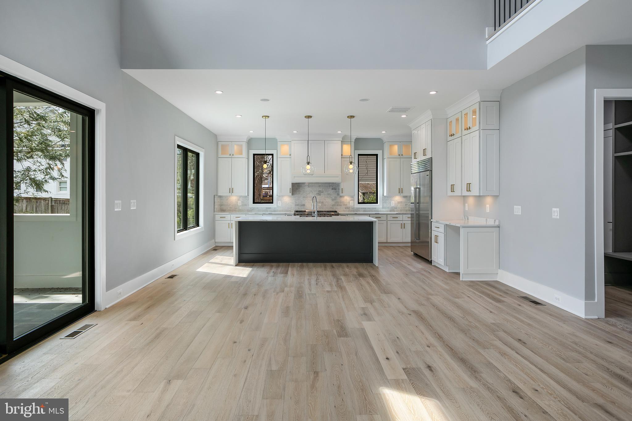 7019 Statendam Court McLean, VA 22101 - Photo 6 of 52 a large kitchen with a wooden floor and stainless steel appliances