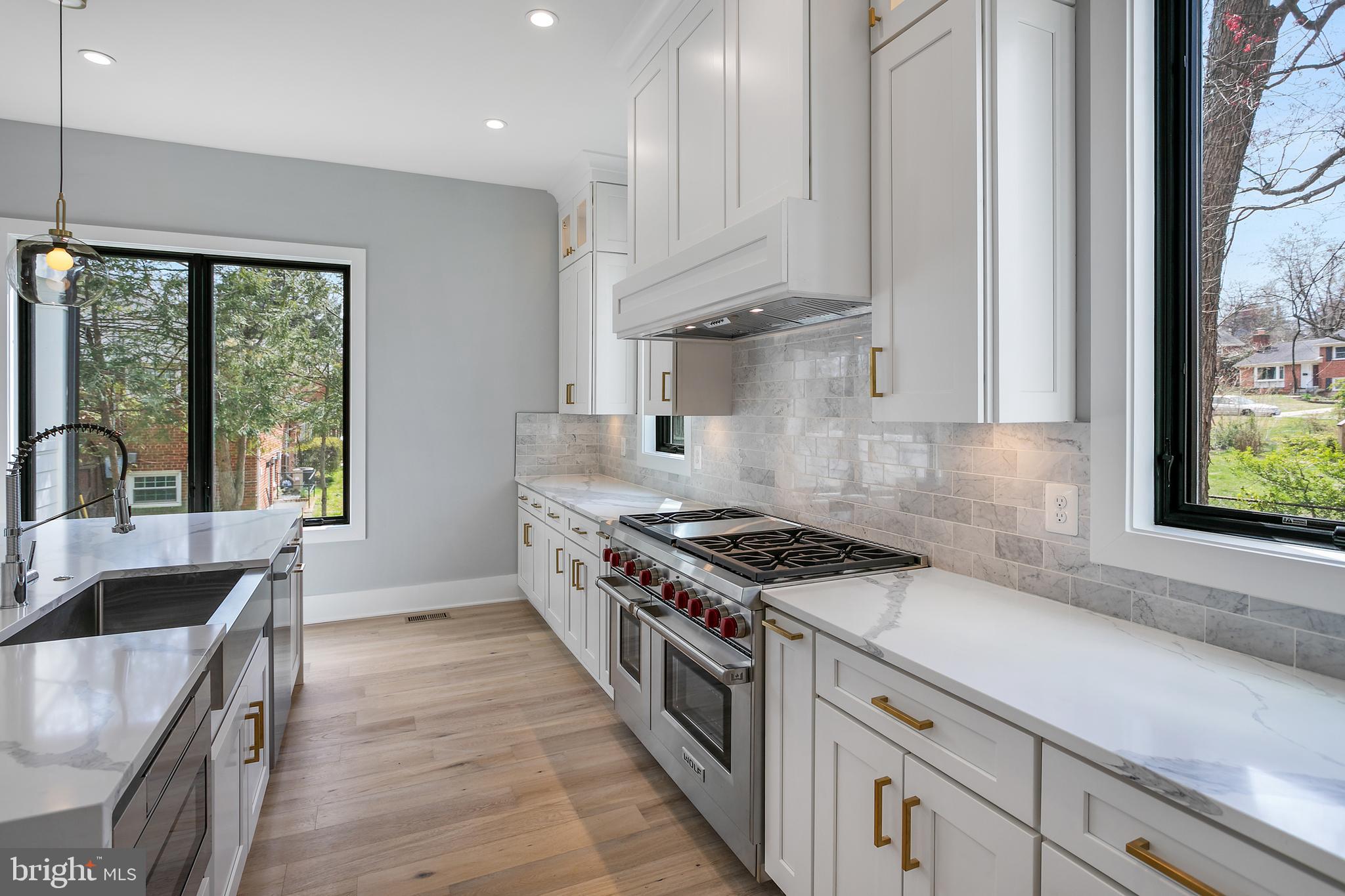 7019 Statendam Court McLean, VA 22101 - Photo 8 of 52 a kitchen with stainless steel appliances granite countertop a stove a sink and a granite counter tops