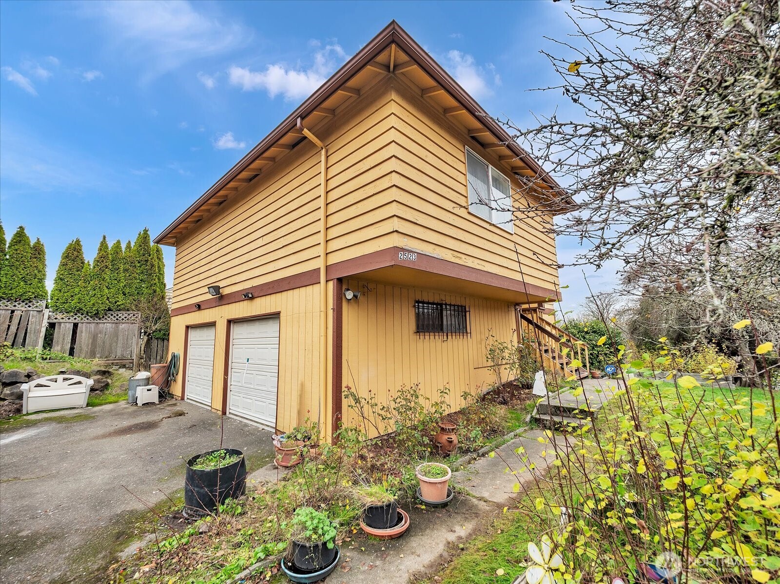 2523 23rd Avenue South Seattle, WA 98144 - Photo 25 of 29 a view of a white house with large windows next to a road