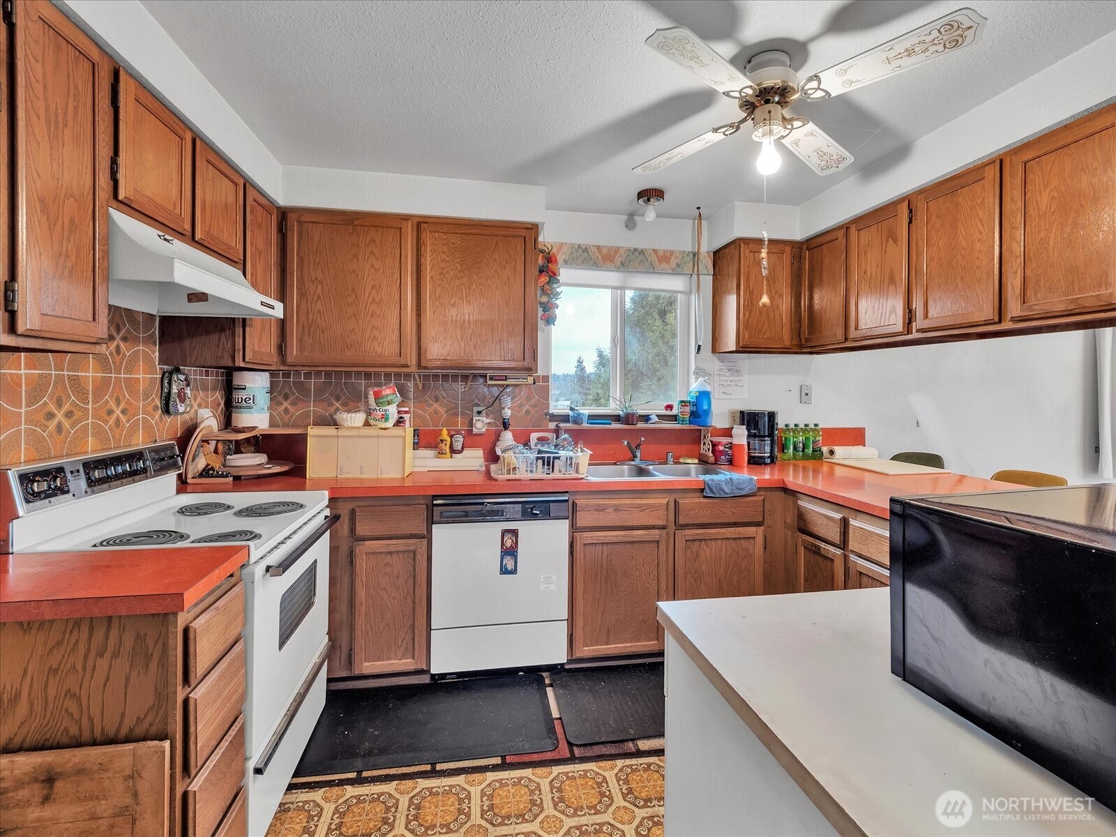 2523 23rd Avenue South Seattle, WA 98144 - Photo 9 of 29 a kitchen with stainless steel appliances granite countertop a sink a stove and cabinets