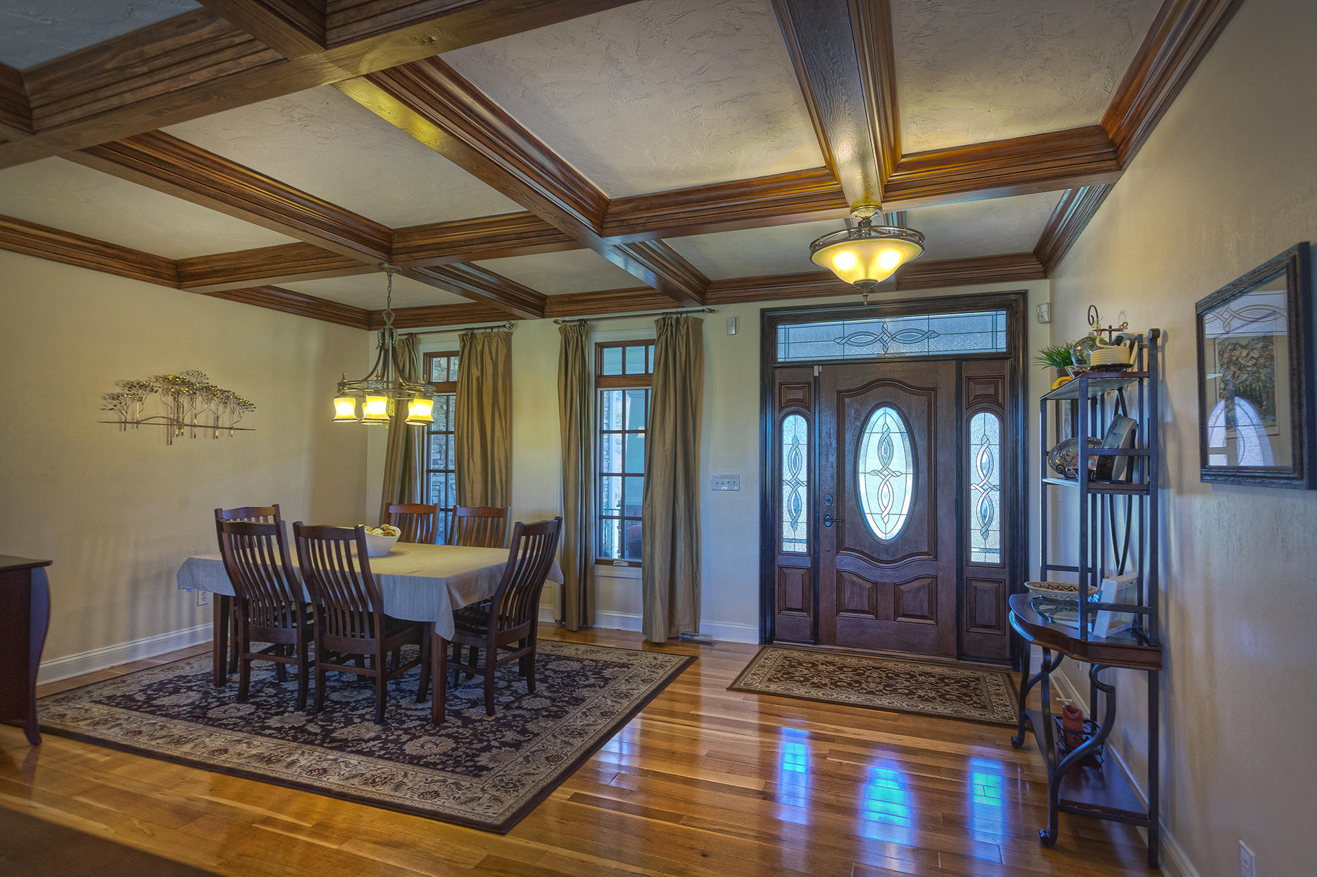 5030 Bethlehem Road Boones Mill, VA 24065 - Photo 3 of 43 a dining room with wooden floor a chandelier a wooden table and chairs