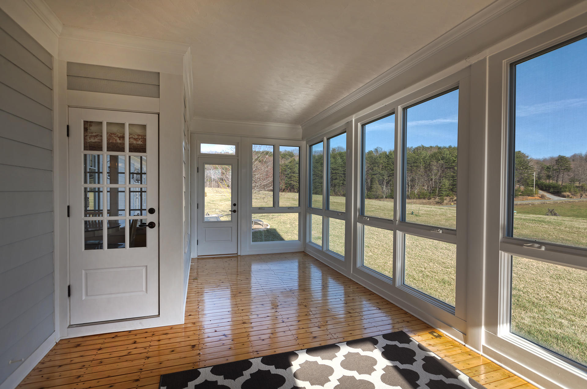 5030 Bethlehem Road Boones Mill, VA 24065 - Photo 23 of 43 a view of a room with wooden floor and floor to ceiling window