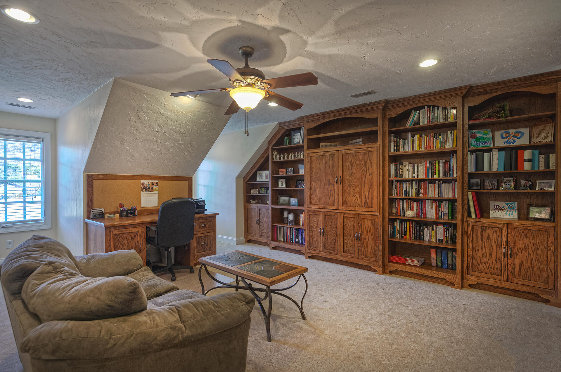 5030 Bethlehem Road Boones Mill, VA 24065 - Photo 28 of 43 a living room with furniture a bookshelf and a bookshelf