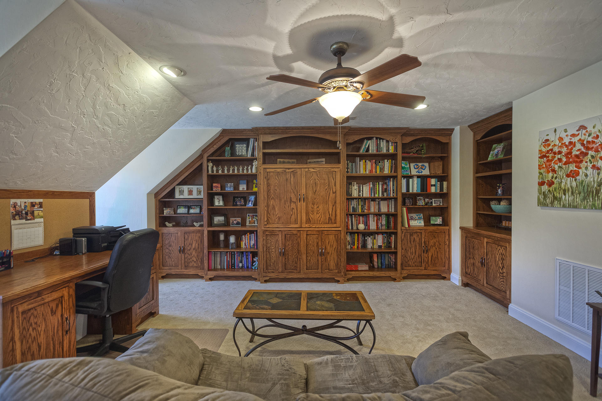 5030 Bethlehem Road Boones Mill, VA 24065 - Photo 29 of 43 a living room with furniture a ceiling fan and a book shelf