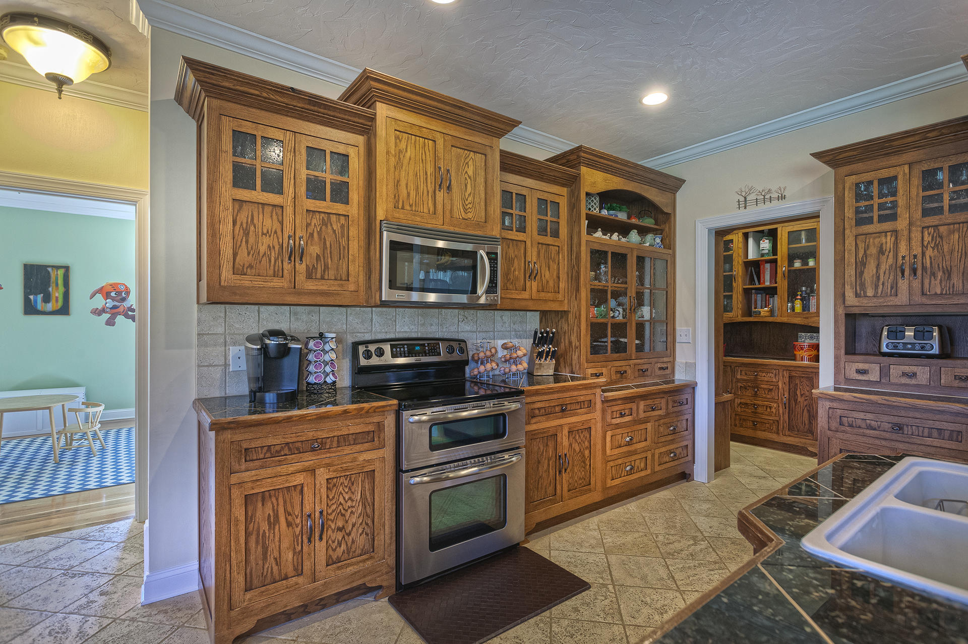 5030 Bethlehem Road Boones Mill, VA 24065 - Photo 9 of 43 a kitchen with stainless steel appliances granite countertop a stove top oven a sink dishwasher a dining table and chairs with wooden floor