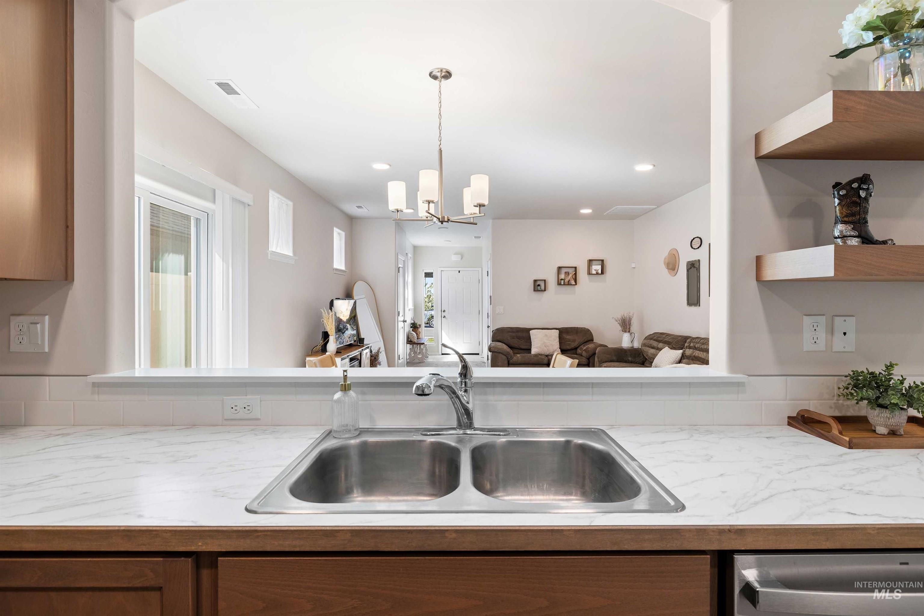 1603 Kenyon Mdw Street Twin Falls, ID 83301 - Photo 32 of 34 Kitchen with light countertops, open floor plan, hanging lights, open shelves, and dishwasher