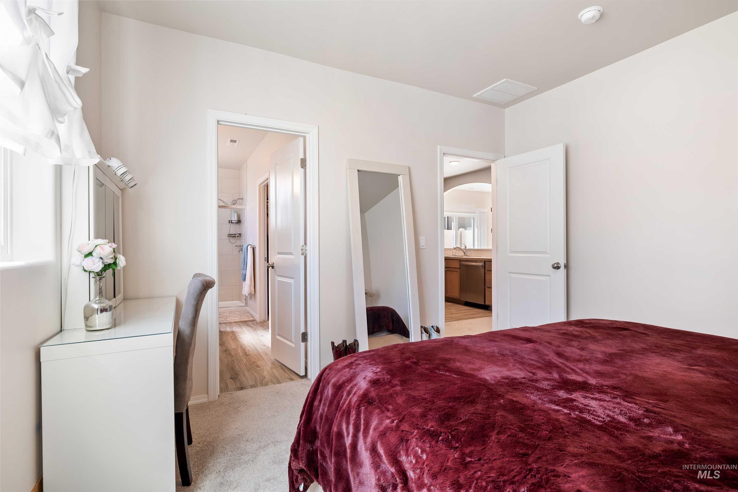 1603 Kenyon Mdw Street Twin Falls, ID 83301 - Photo 11 of 34 Bedroom featuring light colored carpet, ensuite bath, and a walk in closet
