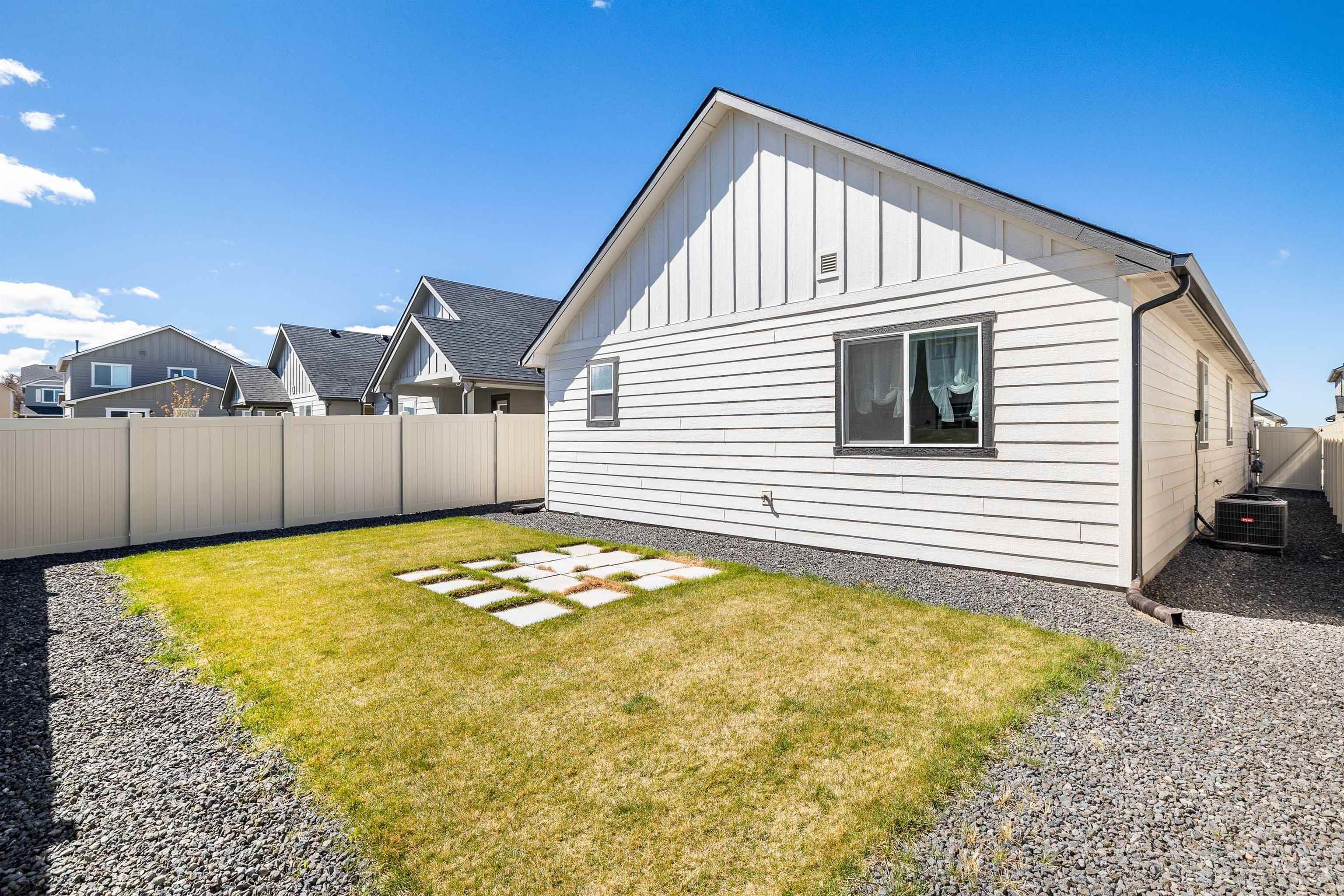 1603 Kenyon Mdw Street Twin Falls, ID 83301 - Photo 20 of 34 View of home's exterior featuring board and batten siding, a fenced backyard, and a residential view