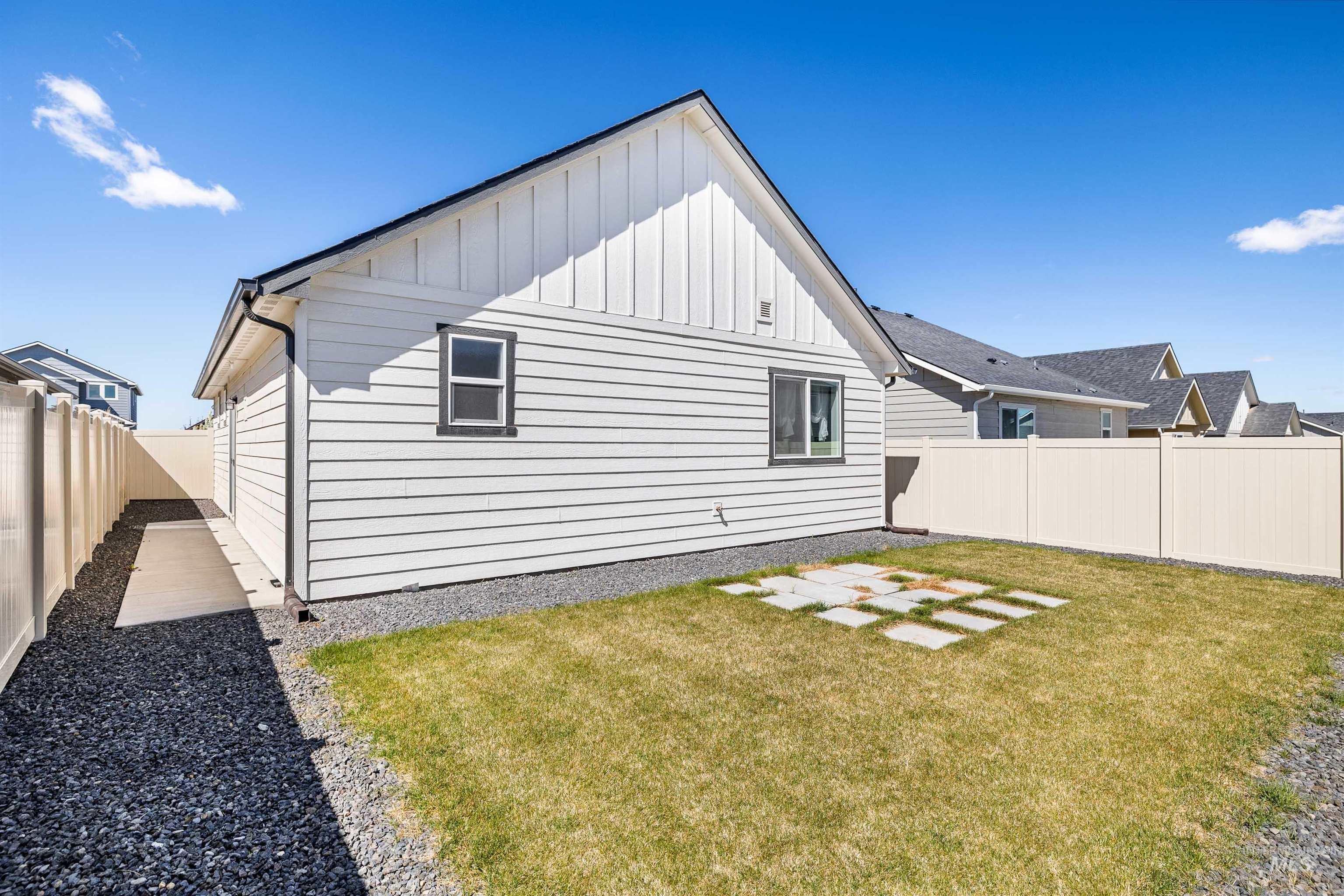 1603 Kenyon Mdw Street Twin Falls, ID 83301 - Photo 21 of 34 Rear view of property with board and batten siding, a fenced backyard, and a patio area