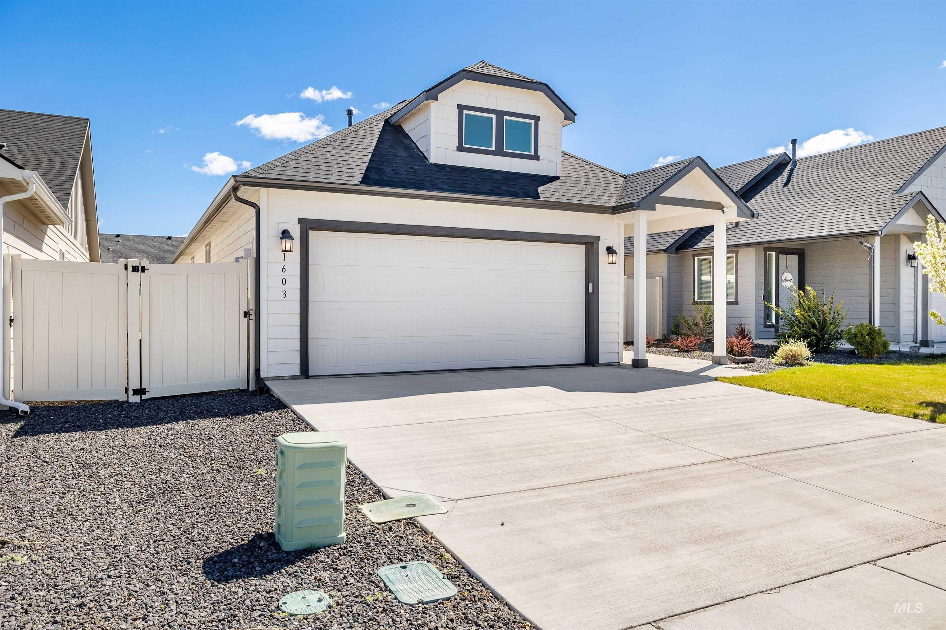 1603 Kenyon Mdw Street Twin Falls, ID 83301 - Photo 22 of 34 View of front of home with roof with shingles, a gate, driveway, and an attached garage
