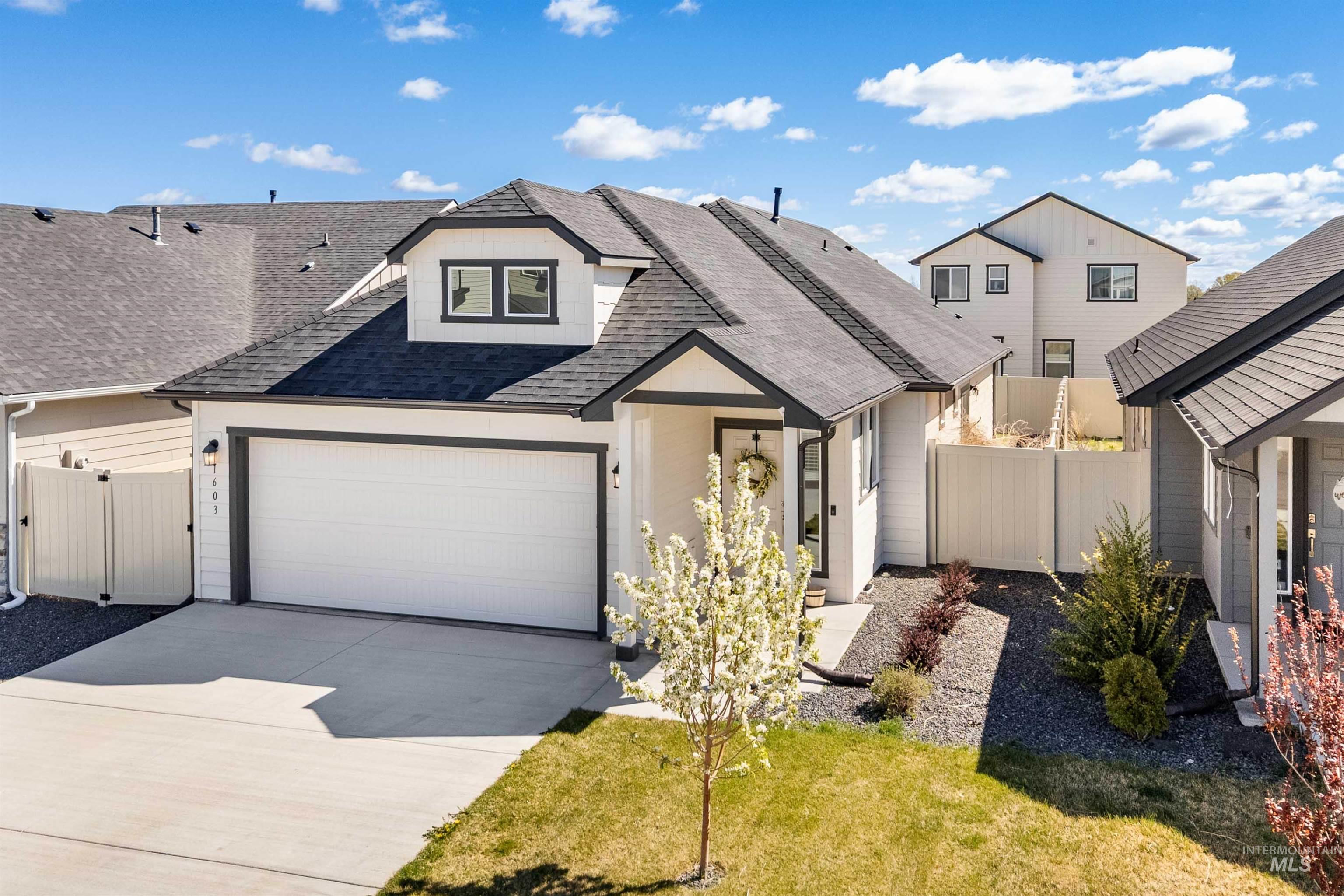 1603 Kenyon Mdw Street Twin Falls, ID 83301 - Photo 30 of 34 View of front of house with roof with shingles, a gate, concrete driveway, and a garage