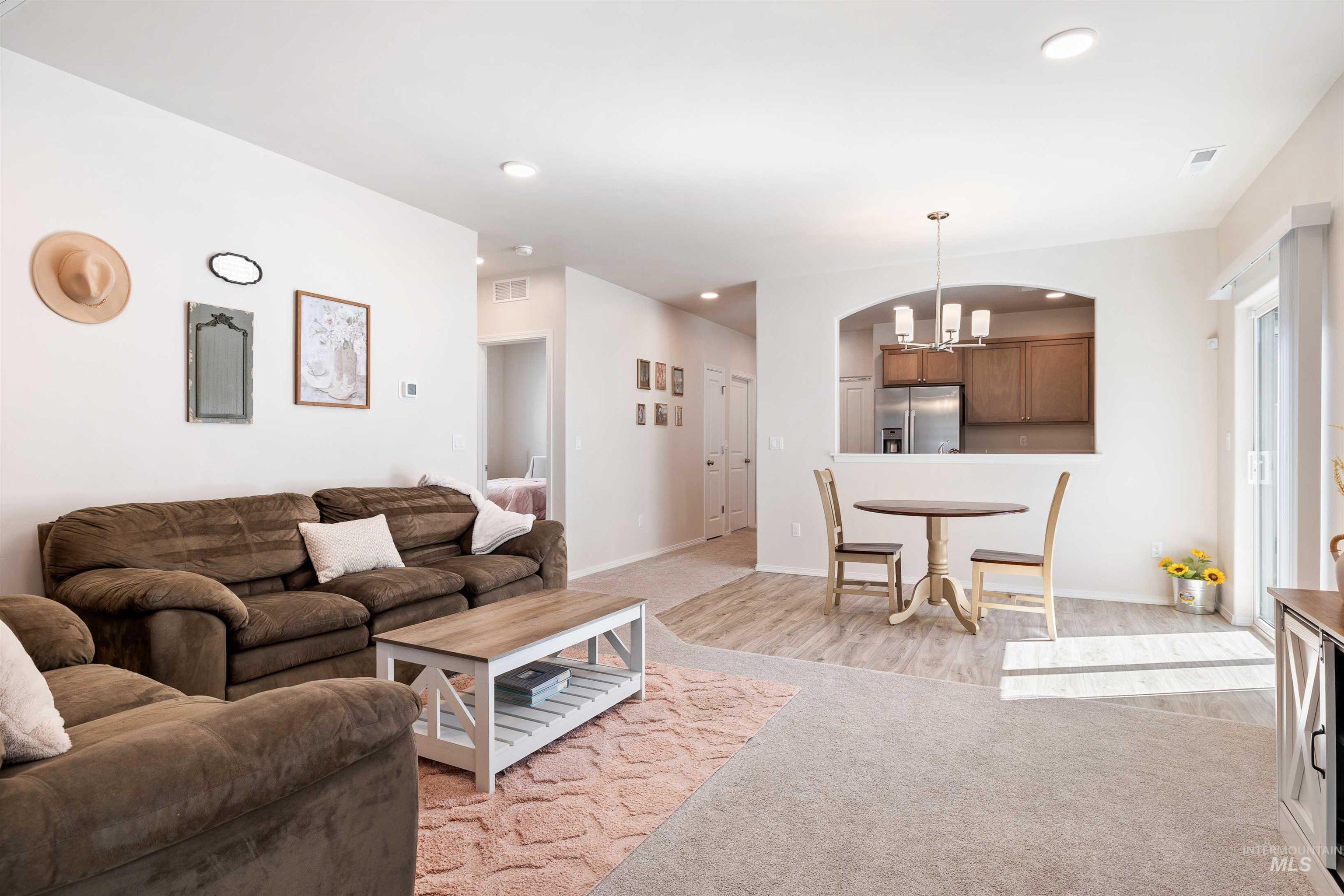 1603 Kenyon Mdw Street Twin Falls, ID 83301 - Photo 5 of 34 Living room featuring light colored carpet and hanging lights