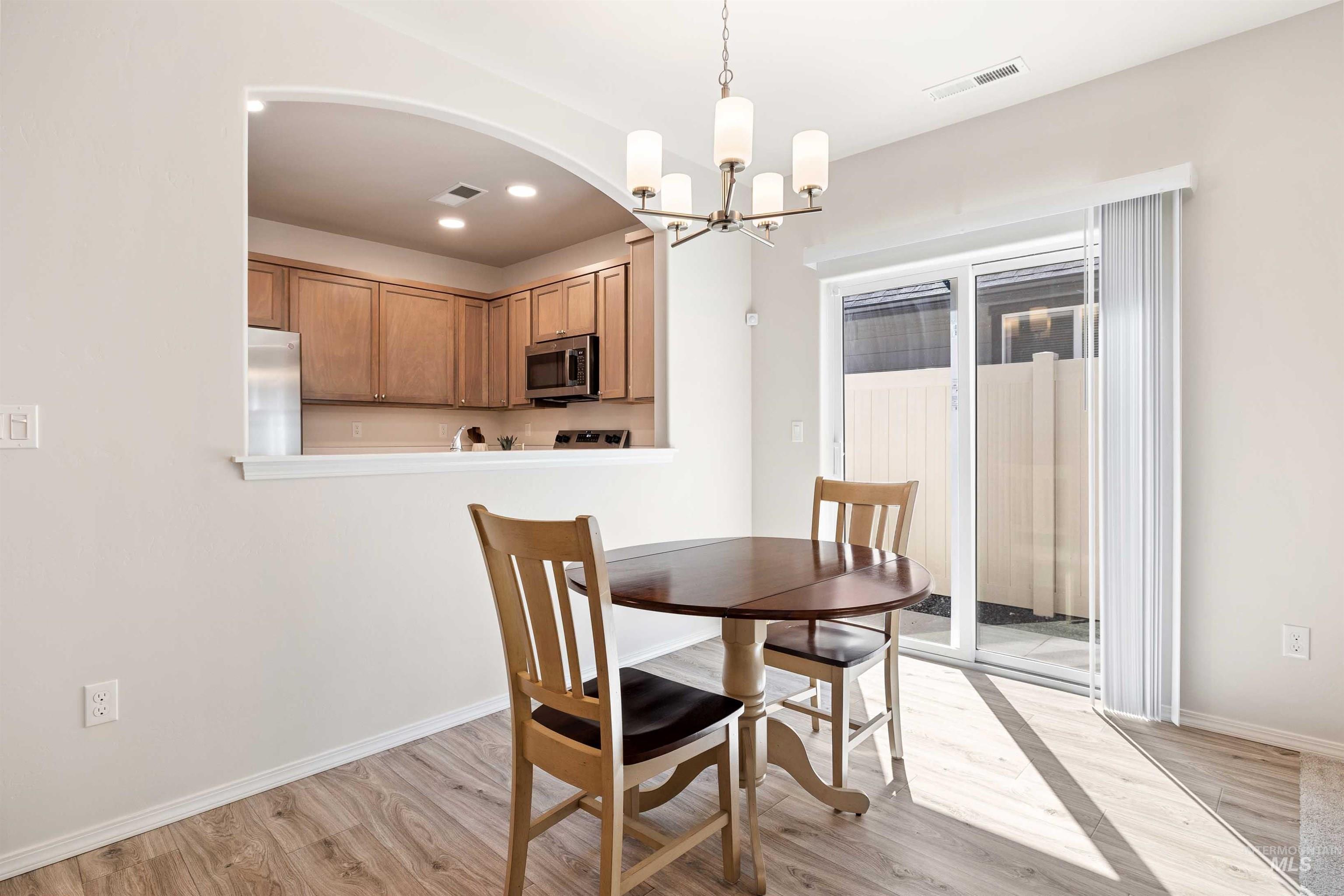 1603 Kenyon Mdw Street Twin Falls, ID 83301 - Photo 8 of 34 Dining room featuring light wood-style flooring and a chandelier