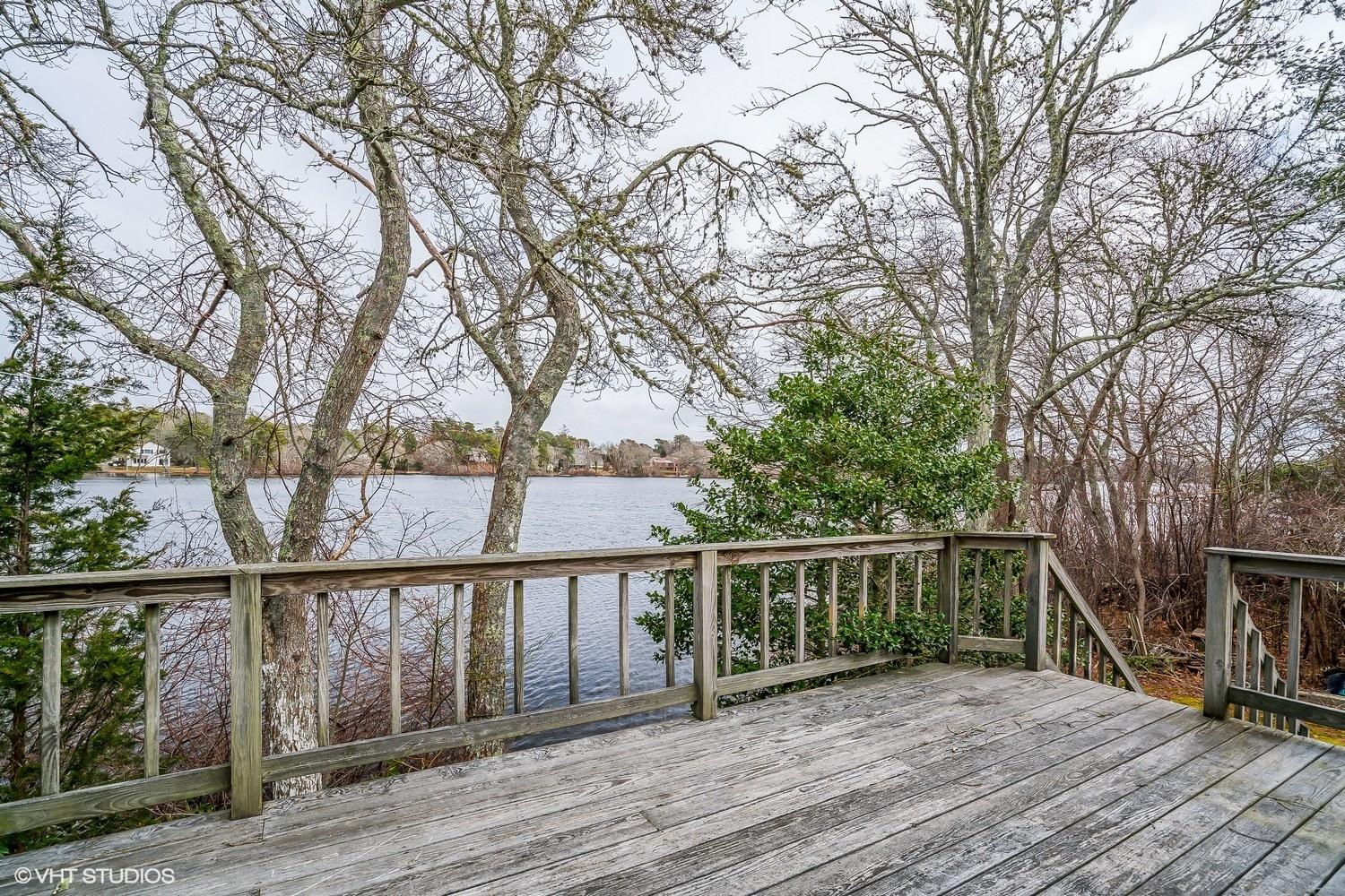 58 Nyes Point Way Centerville, MA 02632 - Photo 14 of 16 a view of a wooden deck and a backyard