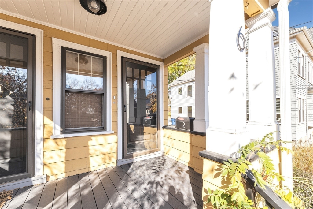 6 Arborough Road, Unit 2 Boston, MA 02131 - Photo 31 of 40 a bedroom with a bed and a large window with outer view
