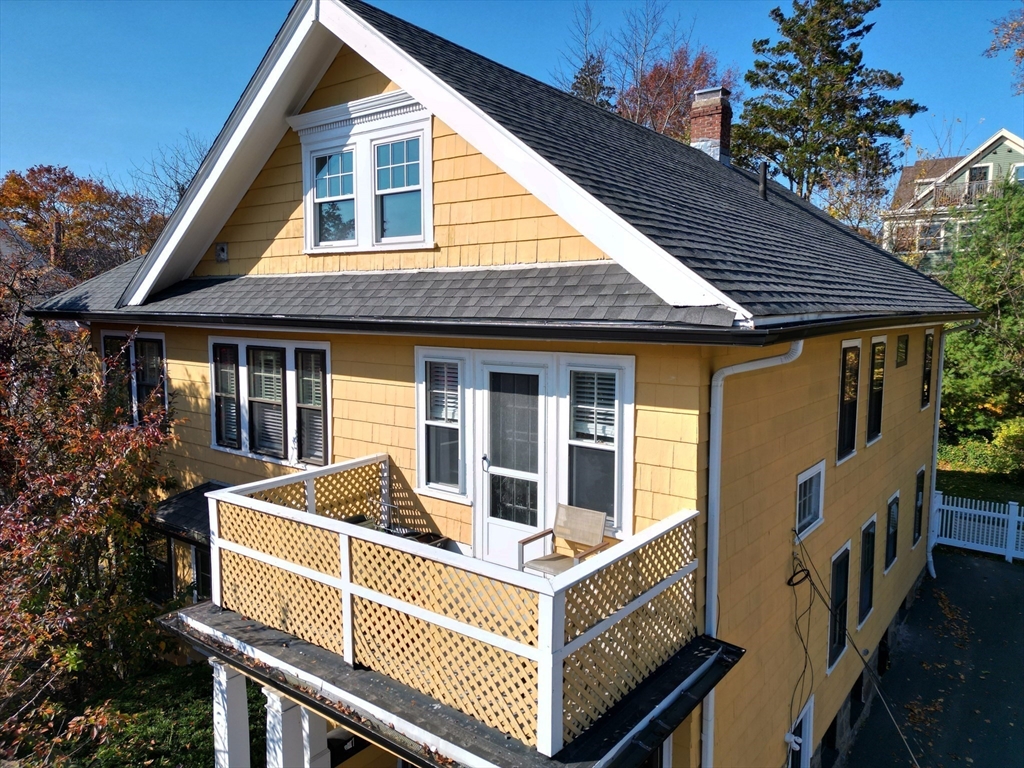 6 Arborough Road, Unit 2 Boston, MA 02131 - Photo 4 of 40 a view of a house with a barbeque and wooden fence