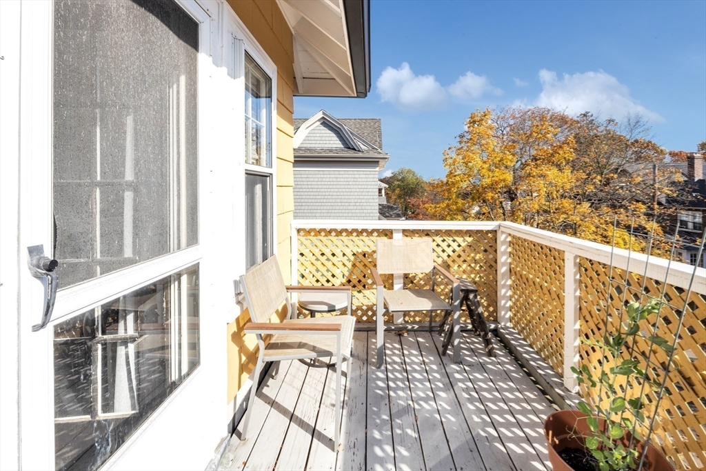 6 Arborough Road, Unit 2 Boston, MA 02131 - Photo 5 of 40 a balcony with wooden floor and outdoor seating
