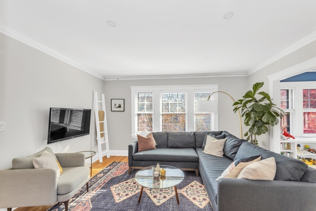 6 Arborough Road, Unit 2 Boston, MA 02131 - Photo 7 of 40 a living room with furniture a flat screen tv and a large window