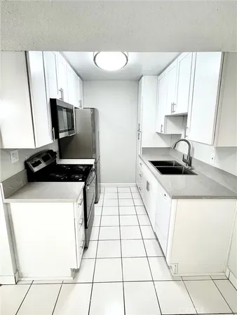 a kitchen with a sink and a stove top oven