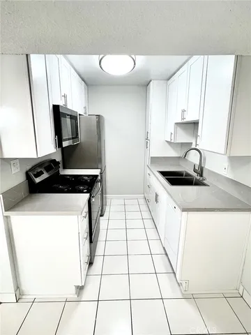 a kitchen with a sink and a stove top oven