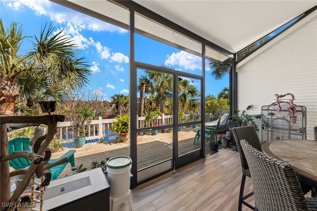 838-840 Rabbit Road Sanibel, FL 33957 - Photo 18 of 38 a dining room with furniture and a floor to ceiling window