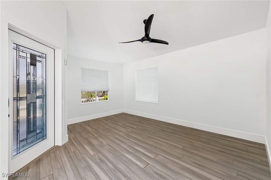 838-840 Rabbit Road Sanibel, FL 33957 - Photo 19 of 38 a view of empty room with wooden floor and fan