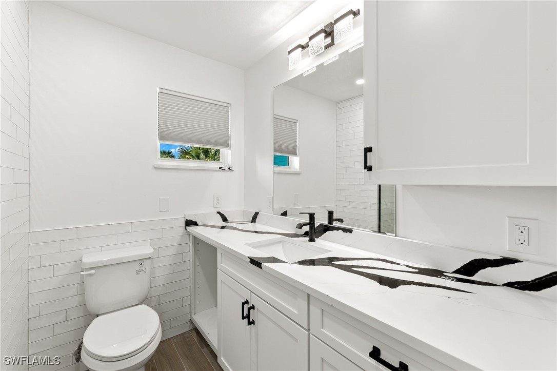 838-840 Rabbit Road Sanibel, FL 33957 - Photo 27 of 38 a bathroom with a sink a toilet and mirror