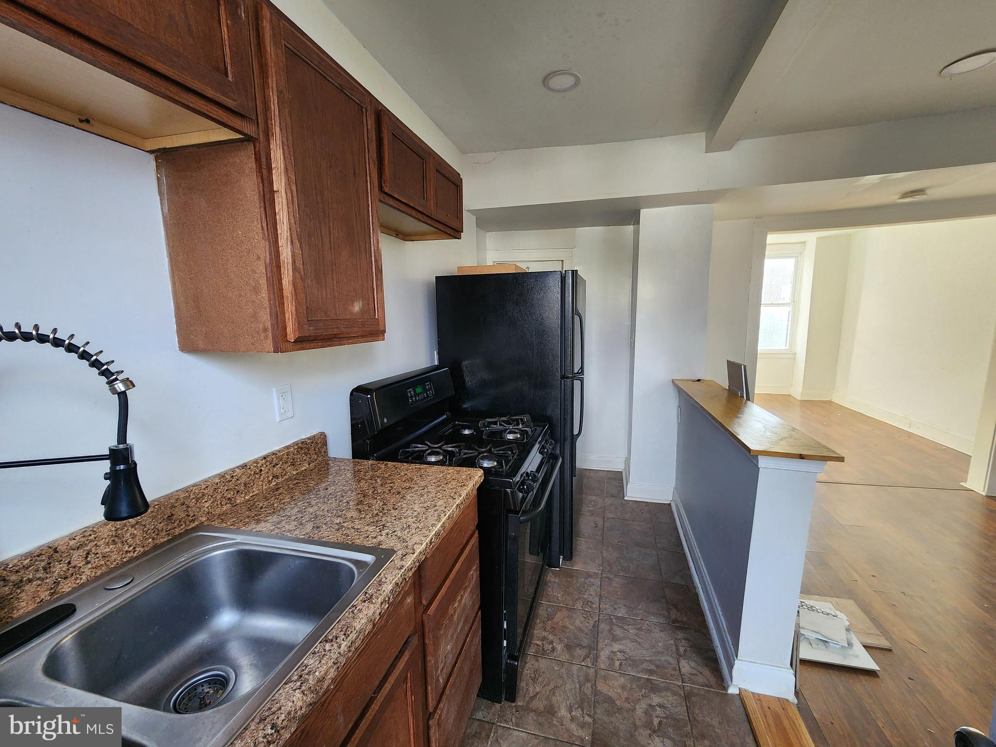 3208 Elmley Avenue Baltimore, MD 21213 - Photo 14 of 30 a kitchen with a sink and a stove top oven