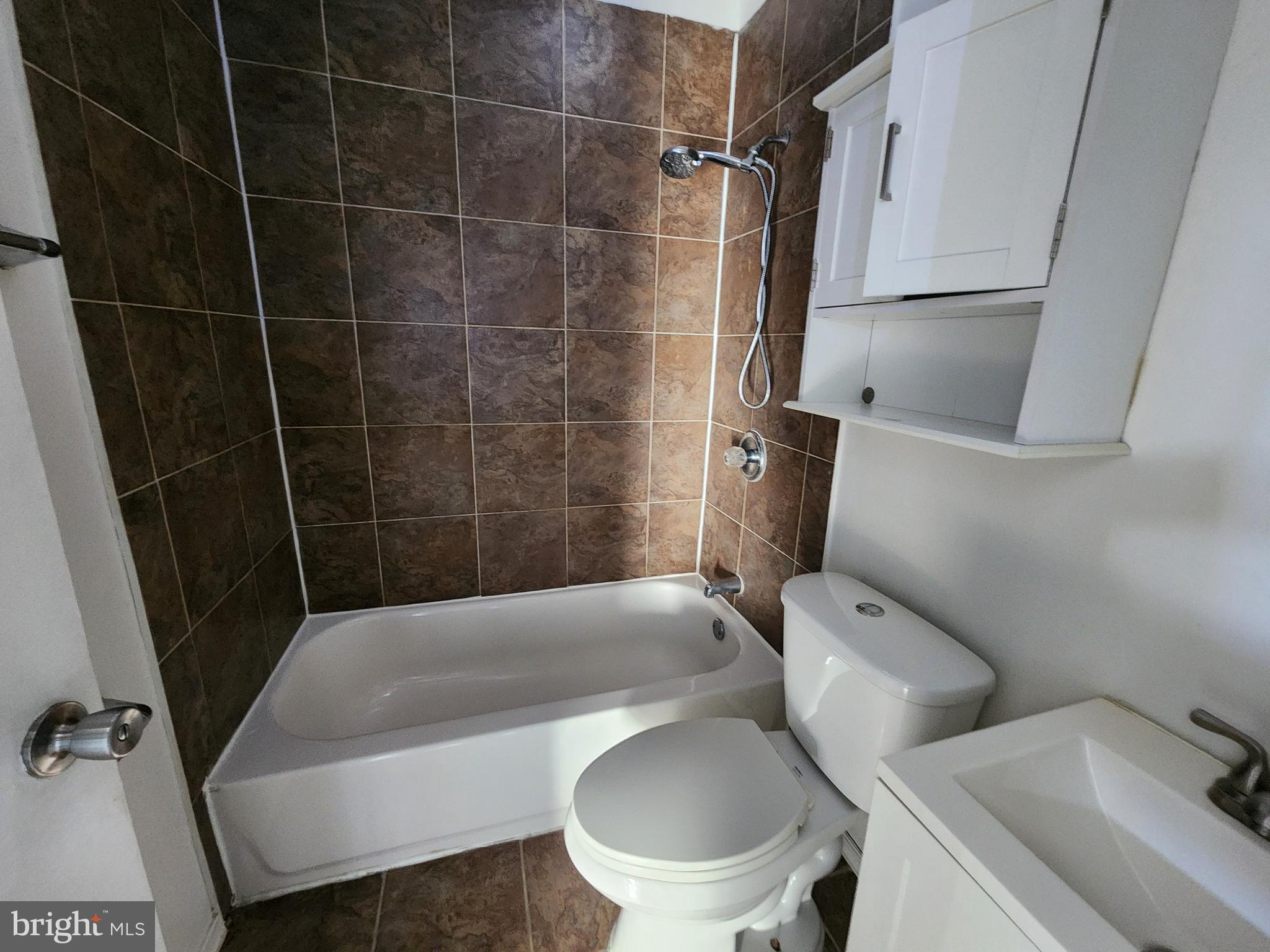 3208 Elmley Avenue Baltimore, MD 21213 - Photo 22 of 30 a white toilet sitting next to a bathroom sink