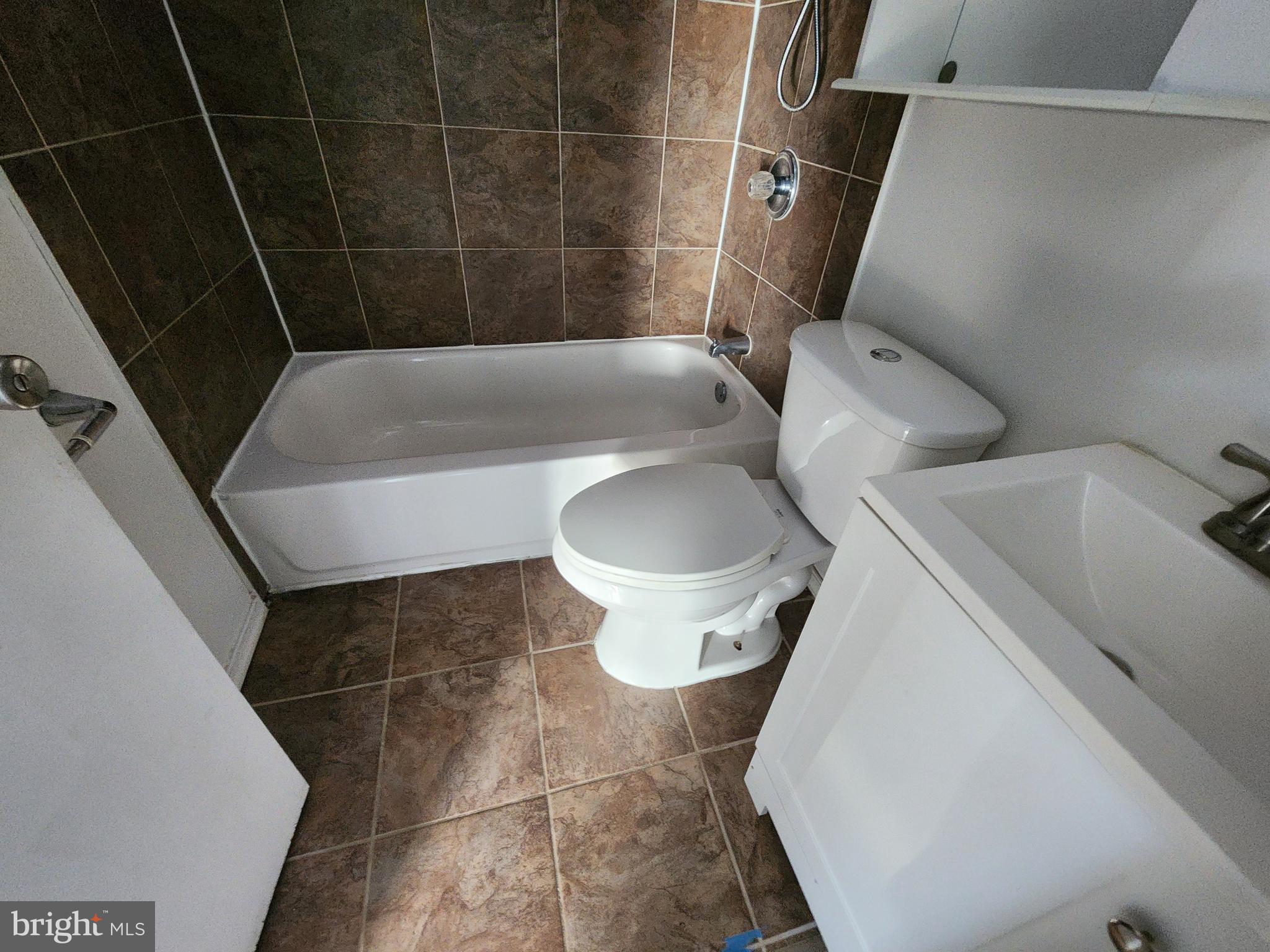 3208 Elmley Avenue Baltimore, MD 21213 - Photo 24 of 30 a bathroom with a sink and toilet
