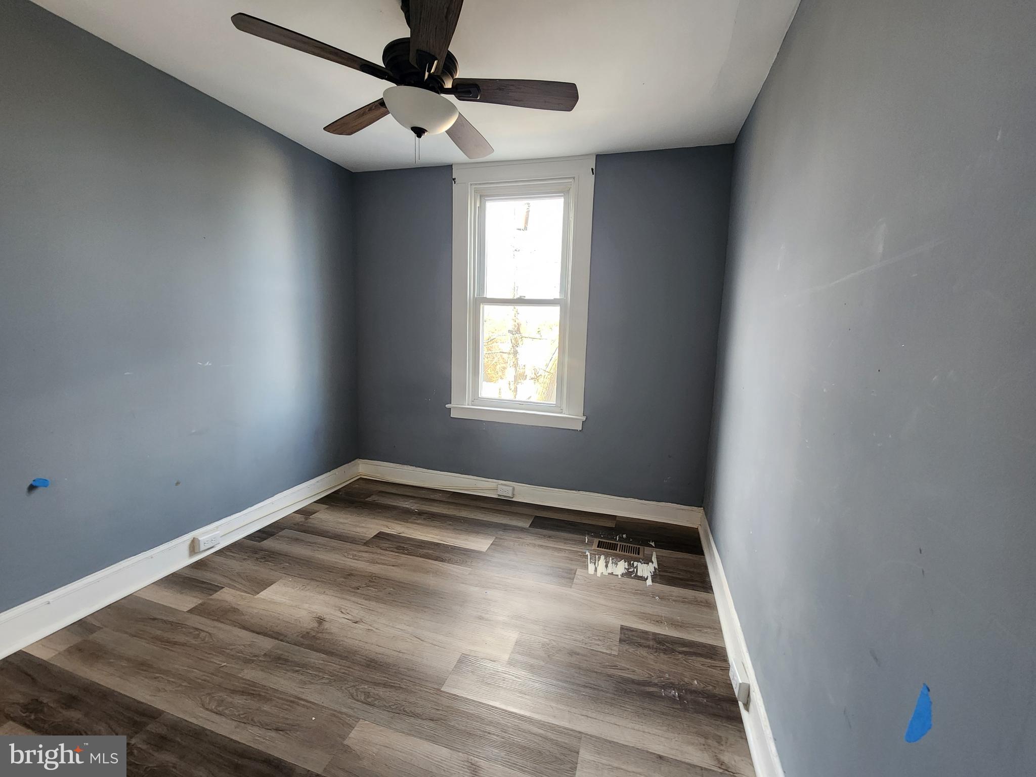 3208 Elmley Avenue Baltimore, MD 21213 - Photo 25 of 30 an empty room with windows and ceiling fan
