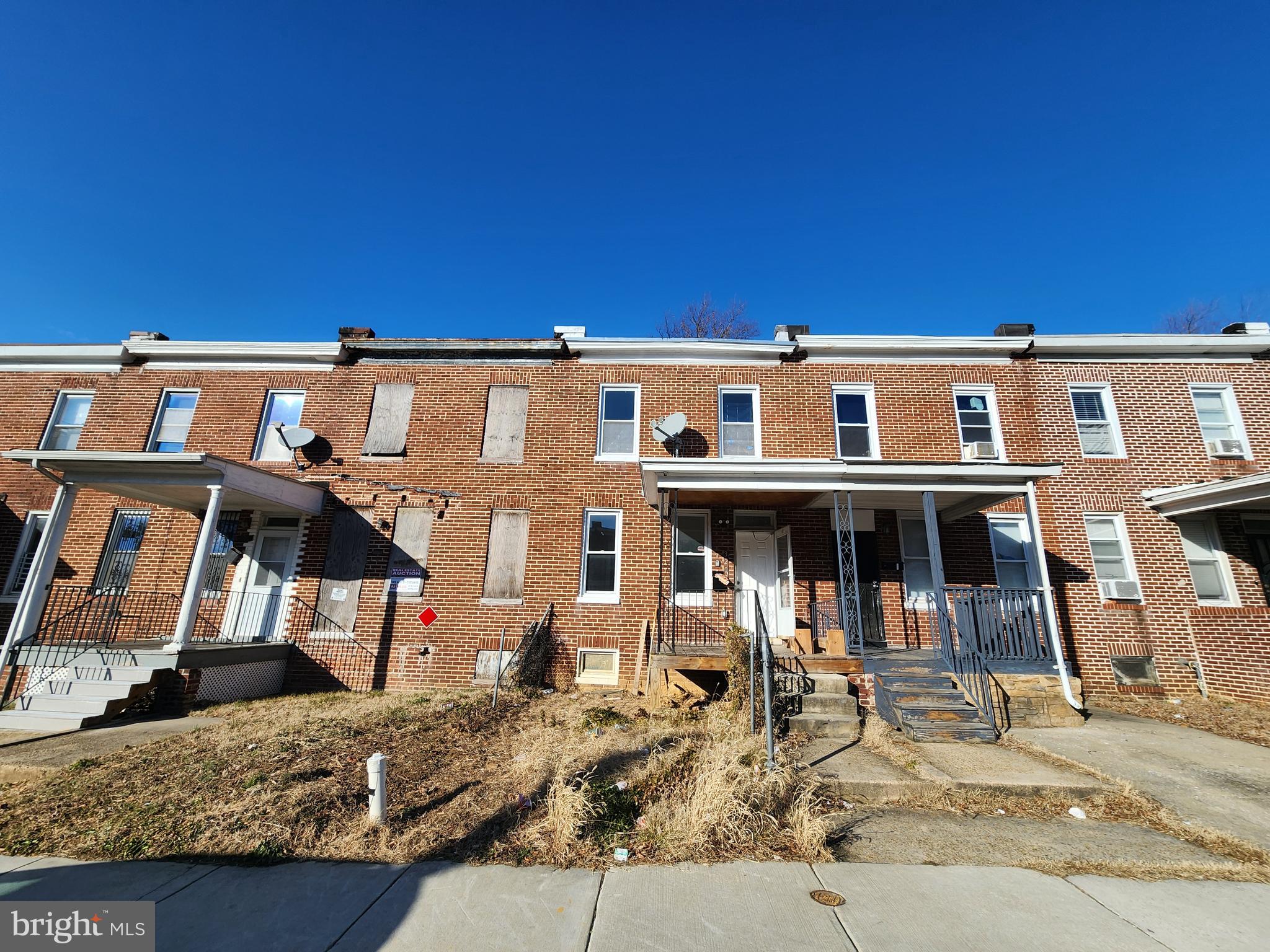 3208 Elmley Avenue Baltimore, MD 21213 - Photo 3 of 30 a front view of a house with large windows