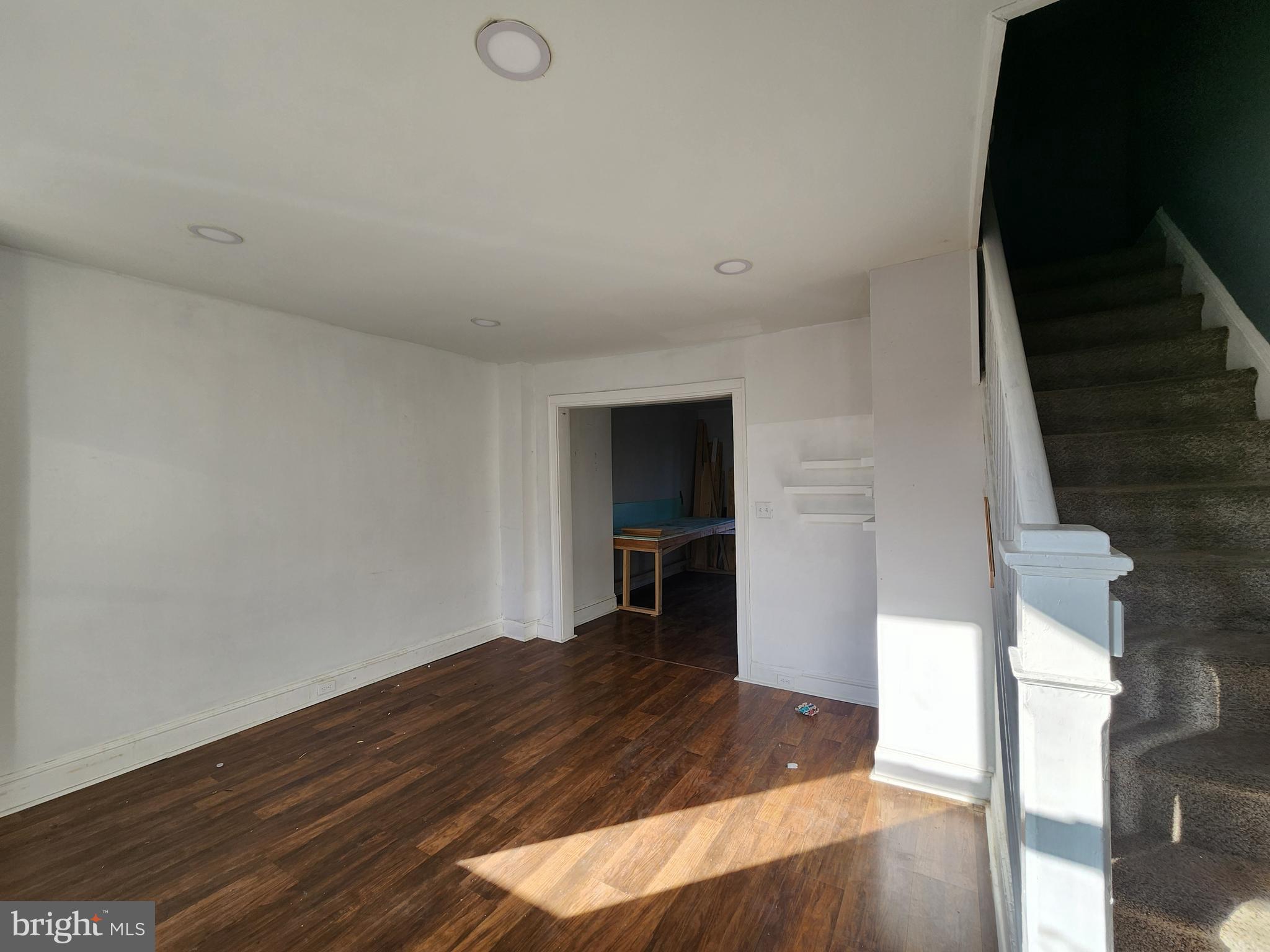 3208 Elmley Avenue Baltimore, MD 21213 - Photo 5 of 30 a view of a room with wooden floor and staircase
