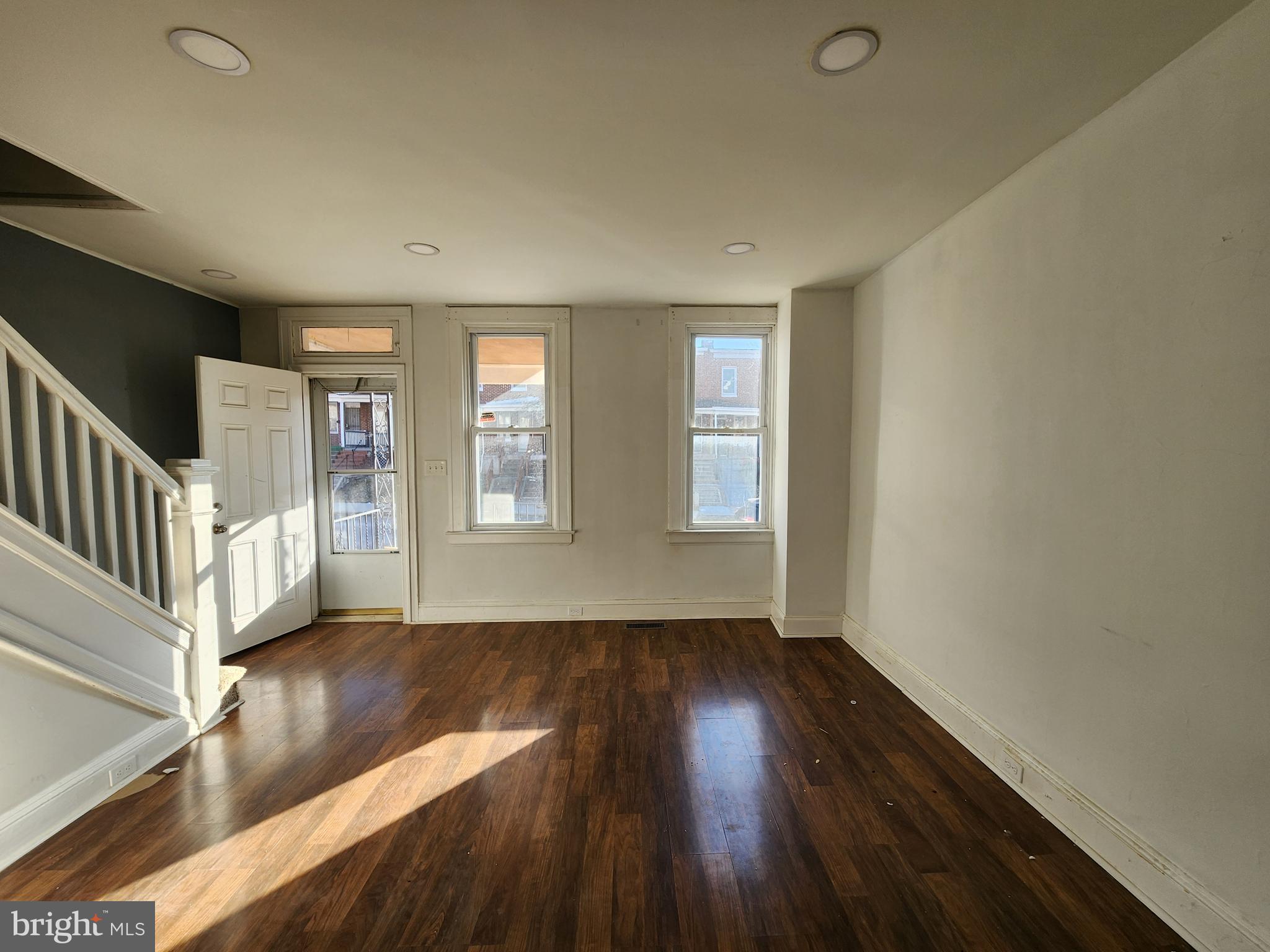 3208 Elmley Avenue Baltimore, MD 21213 - Photo 9 of 30 wooden floor in an empty room with a window