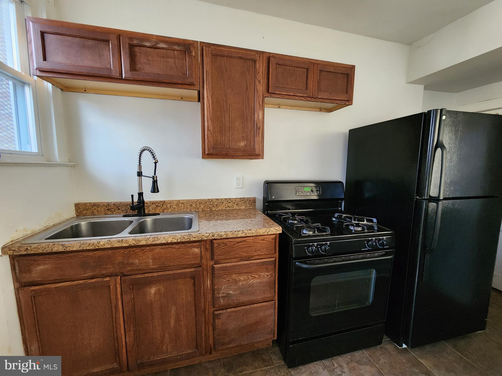 3208 Elmley Avenue Baltimore, MD 21213 - Photo 10 of 30 a kitchen with a stove and a refrigerator