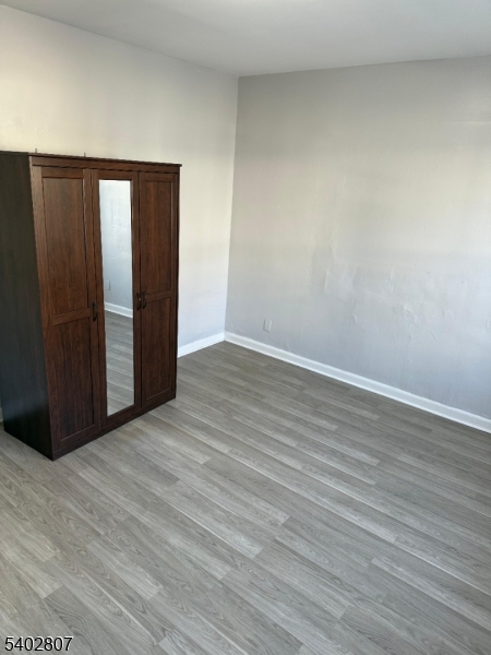 39 Aldine Street Newark, NJ 07112 - Photo 4 of 7 a view of an empty room with wooden floor