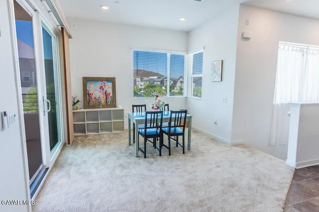 a dining room with furniture and a window