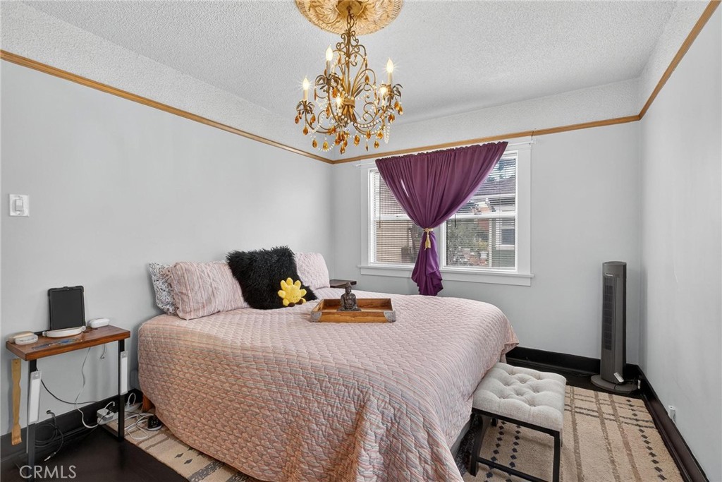 1524 East Hellman Street Long Beach, CA 90813 - Photo 20 of 33 a bedroom with a bed and a chandelier
