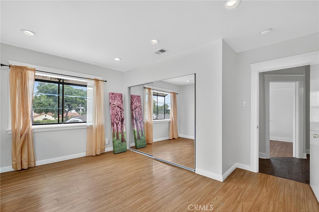 1524 East Hellman Street Long Beach, CA 90813 - Photo 26 of 33 an empty room with wooden floor and windows