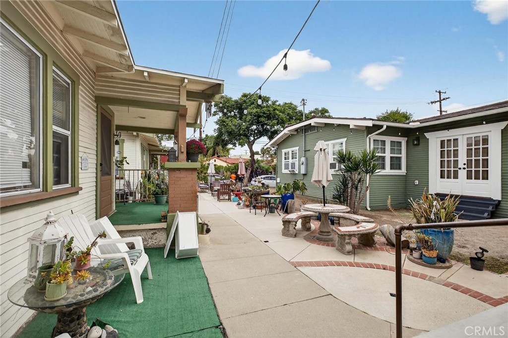 1524 East Hellman Street Long Beach, CA 90813 - Photo 7 of 33 a view of a patio with dining table and chairs under an umbrella