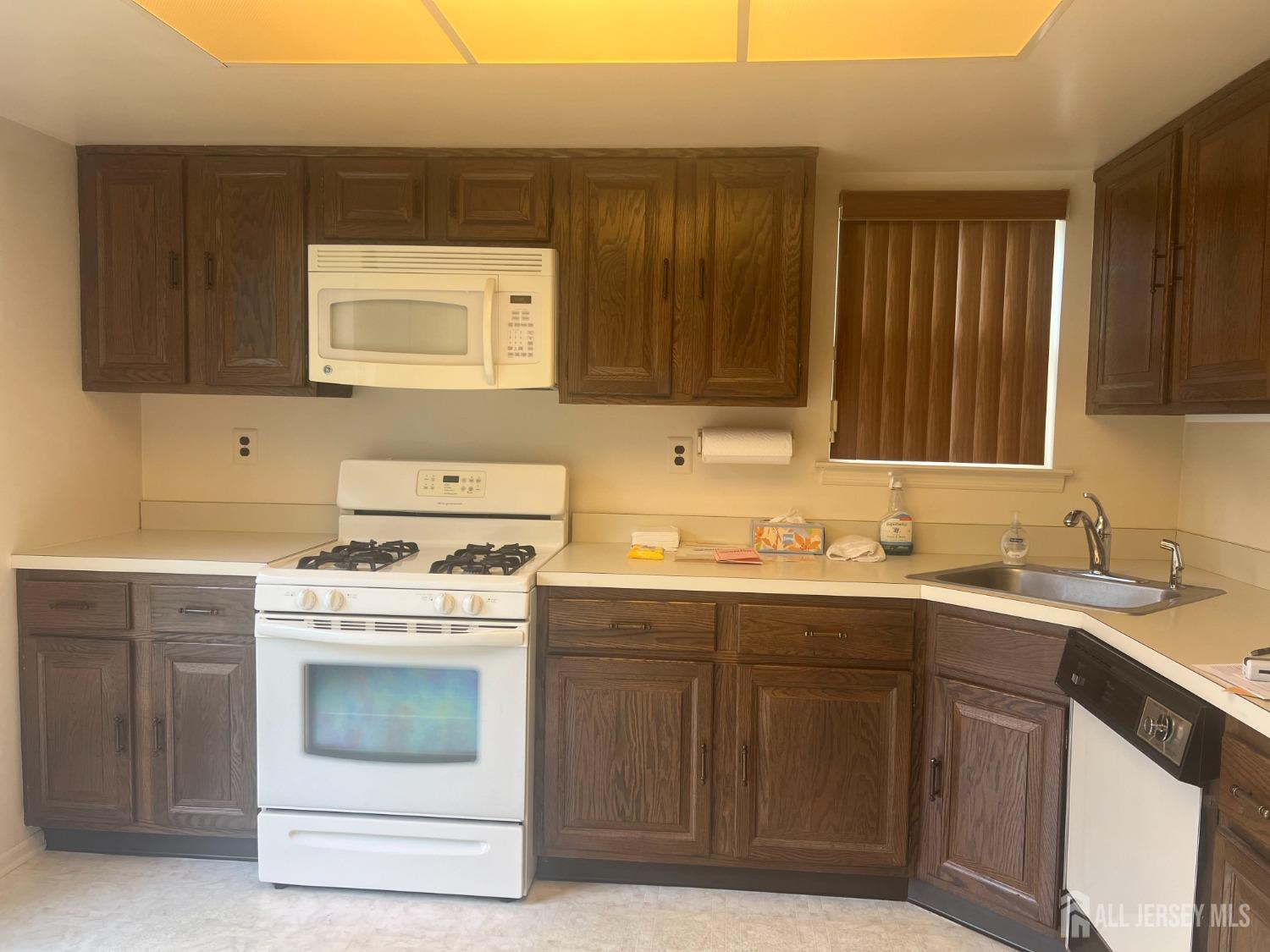143 Archery Court Old Bridge, NJ 08857 - Photo 14 of 29 a kitchen with a sink stove and cabinets
